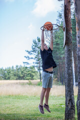 Teenagers Playing Outdoor Basketball in Mountain Landscape