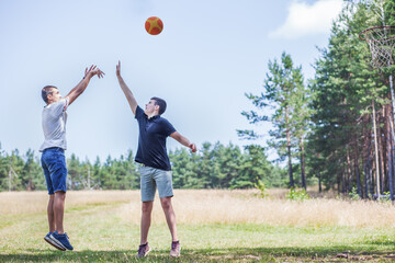 Teenagers Playing Outdoor Basketball in Mountain Landscape