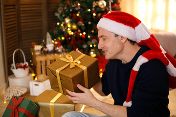 Man with Christmas gifts, Santa hat, cozy festive scene