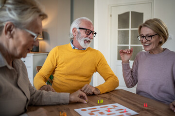 Senior friends enjoying time playing a board game
