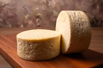 Semi-cured cheese, a wonderful semi-cured cheese from Minas Gerais on a rustic surface, selective focus.
