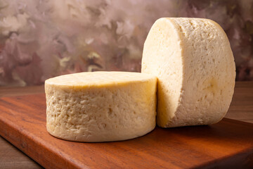 Semi-cured cheese, a wonderful semi-cured cheese from Minas Gerais on a rustic surface, selective focus.