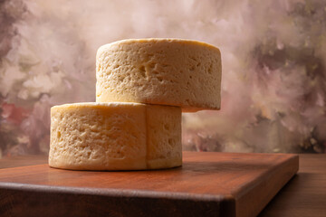 Semi-cured cheese, a wonderful semi-cured cheese from Minas Gerais on a rustic surface, selective focus.