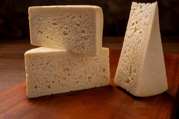 Semi-cured cheese, a wonderful semi-cured cheese from Minas Gerais on a rustic surface, selective focus.