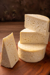 Semi-cured cheese, a wonderful semi-cured cheese from Minas Gerais on a rustic surface, selective focus.