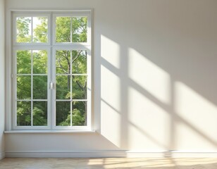 White window frame shows green tree foliage outside. Sunlight casts checkered shadows on a plain wall next to a wooden floor. Empty room offers copy space.