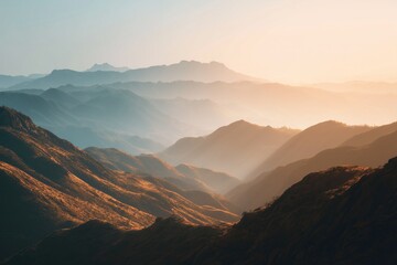 Sunlit rolling hills fade into misty distant peaks under soft gradient sky at serene dawn or dusk