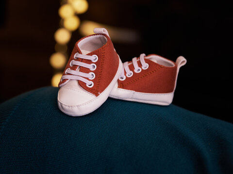 Orange baby shoes with bokeh background