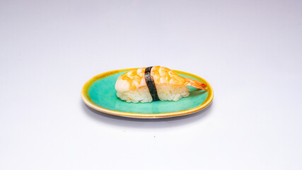 Single ebi nigiri sushi placed on a small plate and photographed on a clean white background, ideal for Japanese cuisine menus, food photography and restaurant promotions.