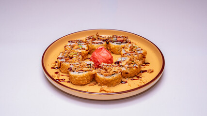 Golden, deep-fried sushi rolls or tempura rolls, photographed on a white background, perfect for Japanese cuisine menus, food photography and restaurant promotions.