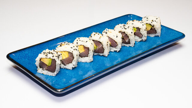 Plate of California rolls, a popular uramaki or inside-out sushi roll, photographed on a white background, perfect for Japanese cuisine menus, food photography, and restaurant promotions.