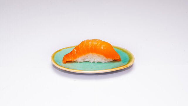 Single salmon nigiri sushi served on a small plate and photographed on a clean white background, perfect for Japanese cuisine menus, food photography and restaurant promotions. - Powered by Adobe