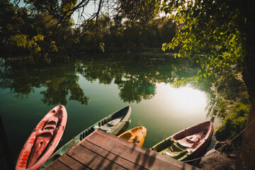 Abandoned kayaks on the lake. A picture of canoe and water boats on a lake