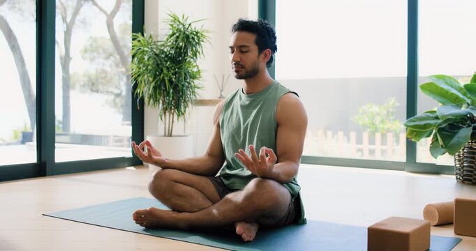 Meditation, relax and yoga with man in home studio for balance, inner peace or mindfulness. Fitness, mudra and zen with yogi person in apartment for holistic health, lotus pose or wellness routine