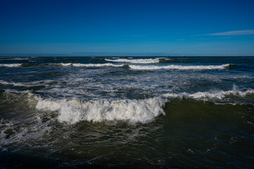 Powerful Ocean Waves Under Clear Blue Sky