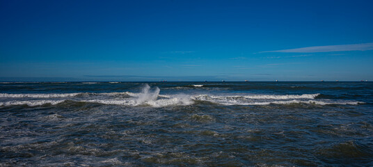 Powerful Ocean Waves Under Clear Blue Sky