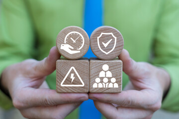 Business person holding wooden blocks with icons symbolizing concept: PUNCTUALITY and ATTENDANCE. Punctuality and Attendance Business Management Concept. Punctual staff.