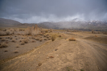 Gravel road through deserted valley leading from Mars Altai Russia. Remote pathway to famous colorful geological landmark.
