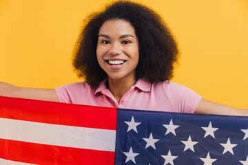 African American woman holding patriotic United States flag
