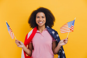 African American woman celebrating holding American flags