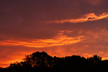 Morning storm over Missouri with heat lightning illuminating the clouds.