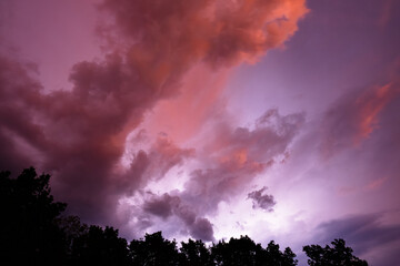 Naklejka premium Morning storm over Missouri with heat lightning illuminating the clouds.