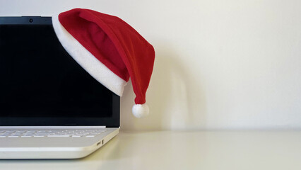 Holiday season laptop with Santa hat