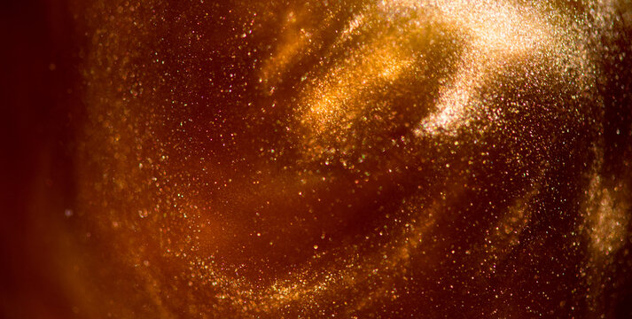 The real photo of Gold particles floating background, Liquid gold, golden abstract backdrop. Beautiful metallic yellow dust texture, Metallic paint close-up. Art Wallpaper waves surface.  - Powered by Adobe