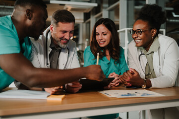 Diverse medical team collaborating on digital tablet