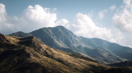 Tranquil panoramic view of rugged mountain range against cloudy sky