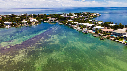 Drone view of Key West coastline with residential houses and boats