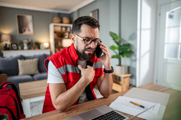 Paramedic man worried during phone call at home office