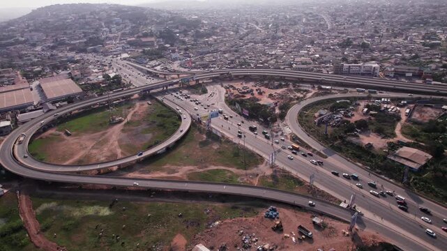 Aerial shot of N1 Highway Interchange cutting through beautiful dense urban Accra landscape