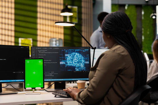 Engineer writing code on green screen tablet, developing machine learning APIs. Admin using chroma key device to troubleshoot software errors using artificial intelligence - Powered by Adobe