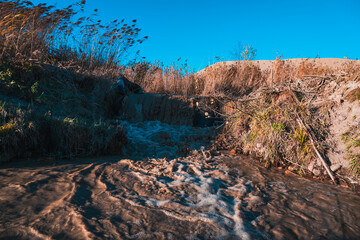 turbulent stream of dirty water in the hills