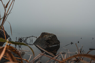 stone by the lake in the mist