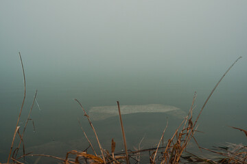 stone by the lake in the mist