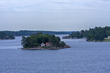 A beautiful landscape of the wide Scandinavian water area with rocky islands. A summer day on the Baltic Sea bay near Stockholm, Sweden.