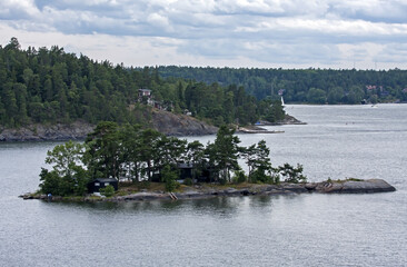 A beautiful landscape of the wide Scandinavian water area with rocky islands. A summer day on the Baltic Sea bay near Stockholm, Sweden.