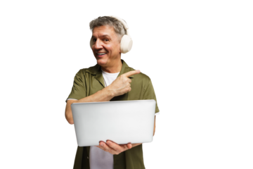 Man smiles while holding laptop and wearing headphones