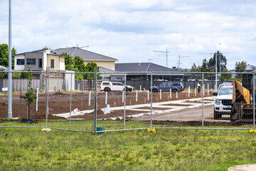 Residential land under construction in Tarneit, Melbourne&rsquo;s outer-west suburbs, with fenced-off lots, groundwork preparation, and surrounding modern houses. Concept of suburban expansion, new housing 