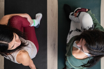 Women performing gentle stretches on yoga mats for physical and mental wellness
