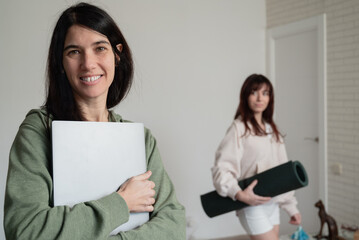 Two women combining digital work and fitness activities for a balanced lifestyle