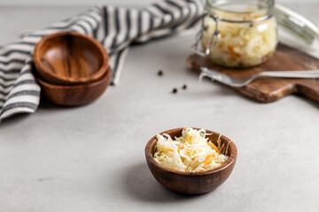 Sauerkraut with carrots in a wooden bowl.