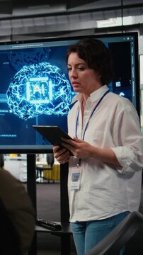 Vertical video Tech startup office CTO doing presentation on machine learning technology to interested investors. IT specialist using display to show business stakeholders latest AI innovations