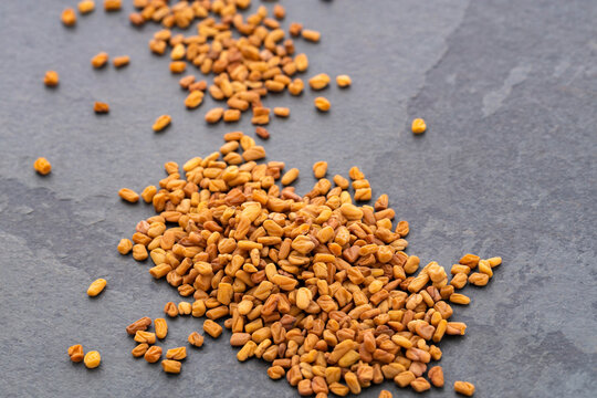Pile of natural organic fenugreek seeds - Trigonella foenum - graecum