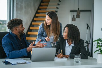 Diverse start up business team collaborating on laptop strategy