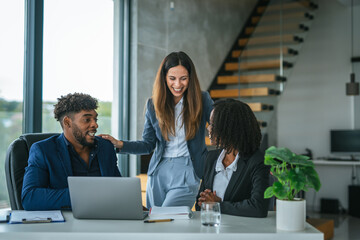 Diverse start up business team collaborating on laptop strategy