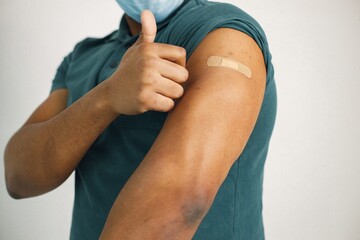 Black guy isolated on white background after covid vaccination
