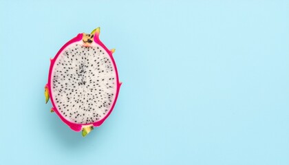 Vibrant Pink Dragon Fruit Half Showing White Flesh and Tiny Black Seeds Centered on a Light Blue Background
